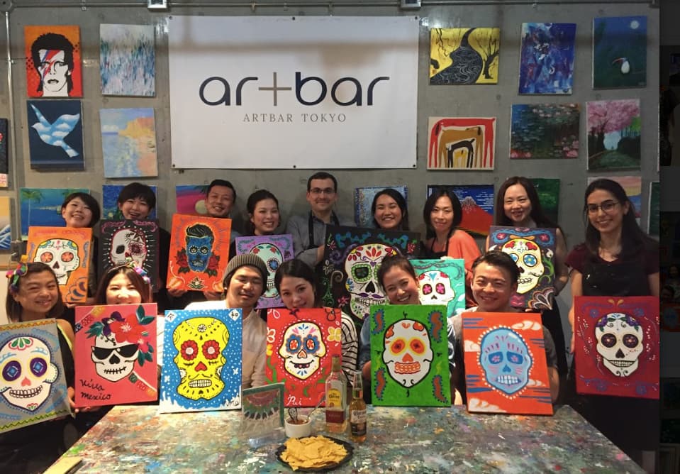 Dia de los muertos class at Artbar Tokyo, with people showing colorfull skulls they painted